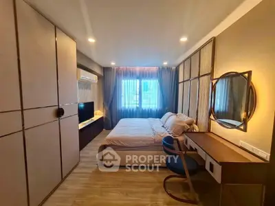Modern bedroom with stylish decor, large window, and elegant furnishings in a cozy apartment.
