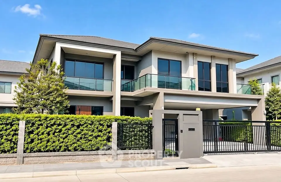 Luxurious modern two-story house with large windows and lush greenery, perfect for upscale living.
