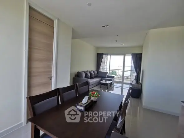 Spacious living room with modern dining area and large windows for natural light.