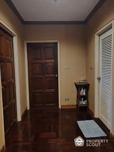 Charming hallway with wooden doors and parquet flooring in cozy home