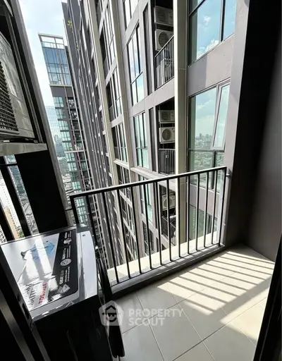 Modern high-rise balcony with city view and air conditioning units.