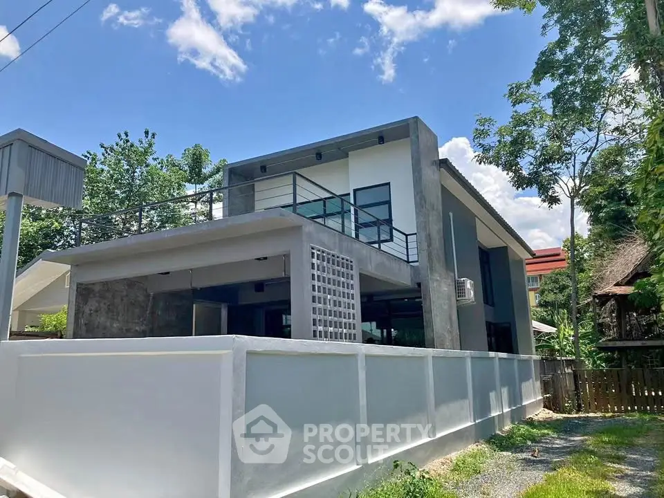 Modern two-story house with sleek design and spacious balcony in a serene neighborhood.