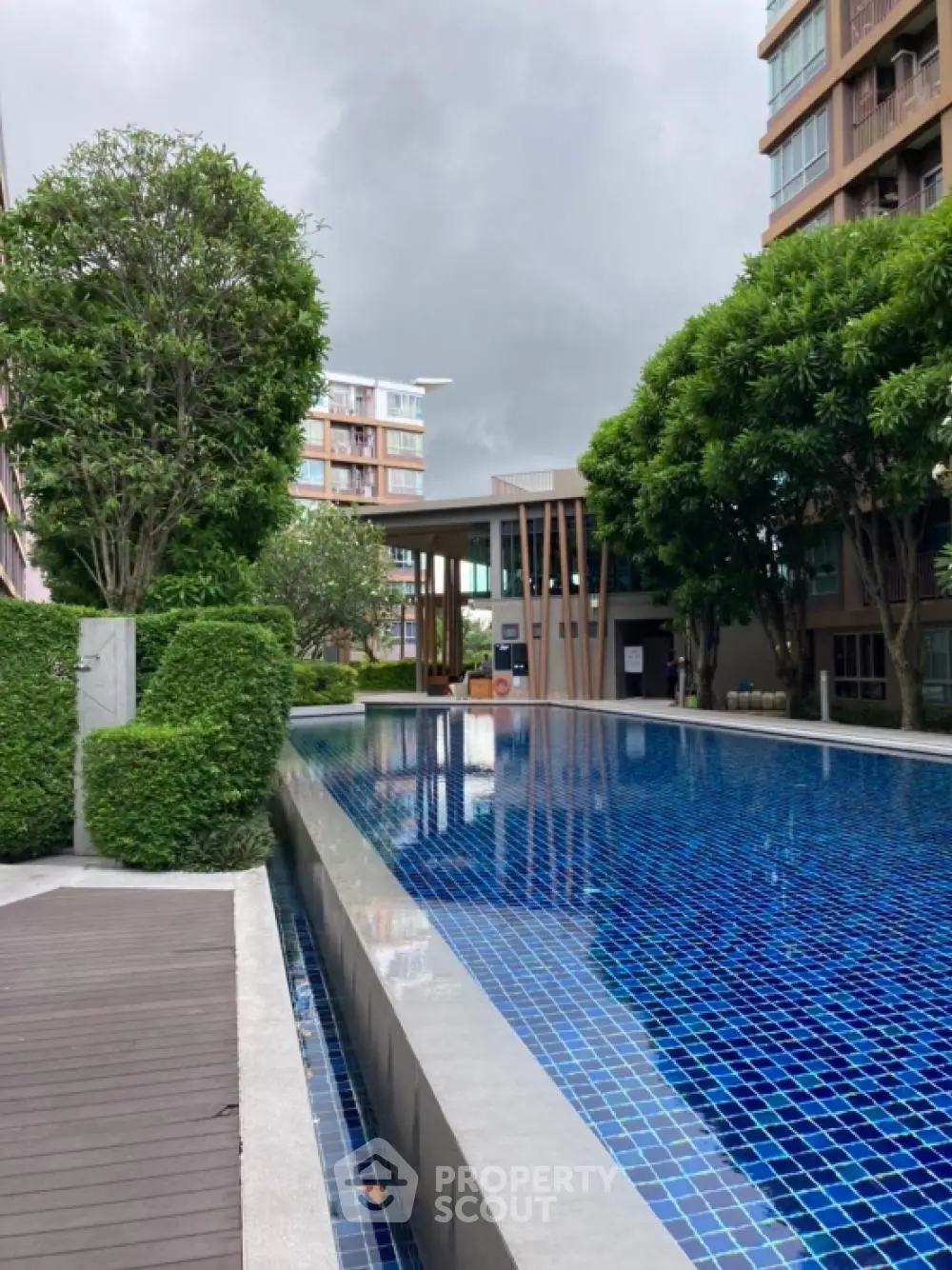 Luxurious condominium with stunning pool and lush greenery, perfect for relaxation and leisure.