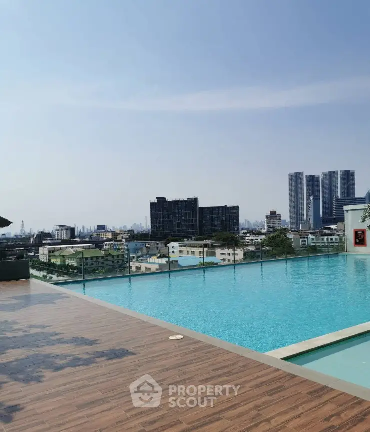 Stunning rooftop pool with panoramic city skyline views, perfect for luxury urban living.