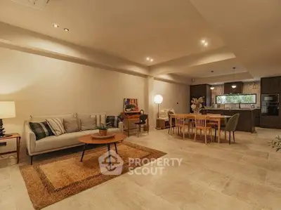 Spacious open-plan living room with modern kitchen and stylish decor