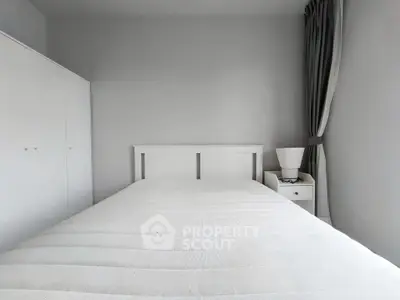 Minimalist bedroom with white furniture and soft lighting