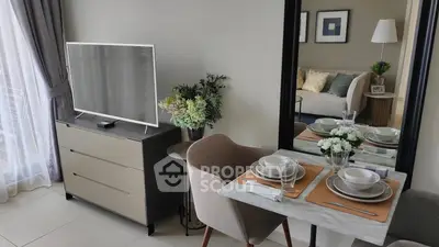 Modern living room with elegant dining setup and flat-screen TV, perfect for cozy gatherings.