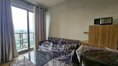 Modern living room with city view, featuring sleek furniture and large windows for natural light.