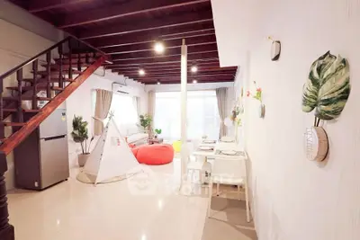 Spacious living room with modern decor and open layout, featuring a cozy seating area and dining space.