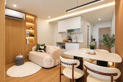 Modern open-plan living room and kitchen with stylish decor and cozy ambiance.