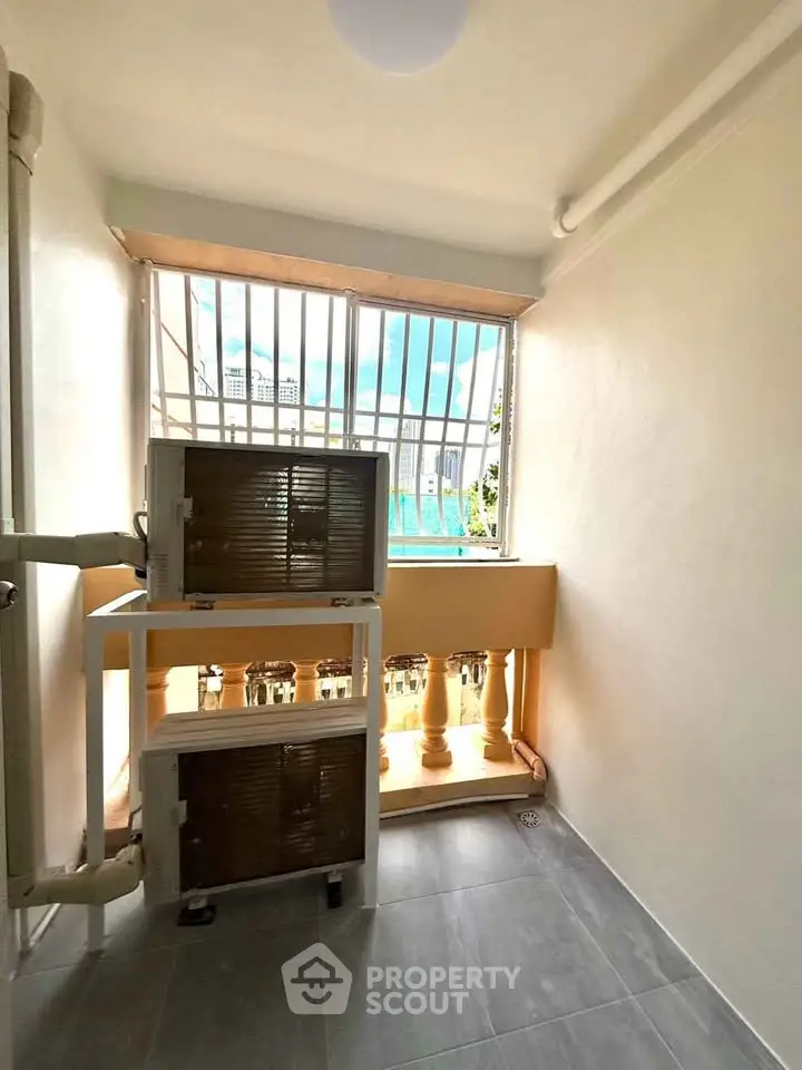 Compact utility area with air conditioning units and bright natural light.