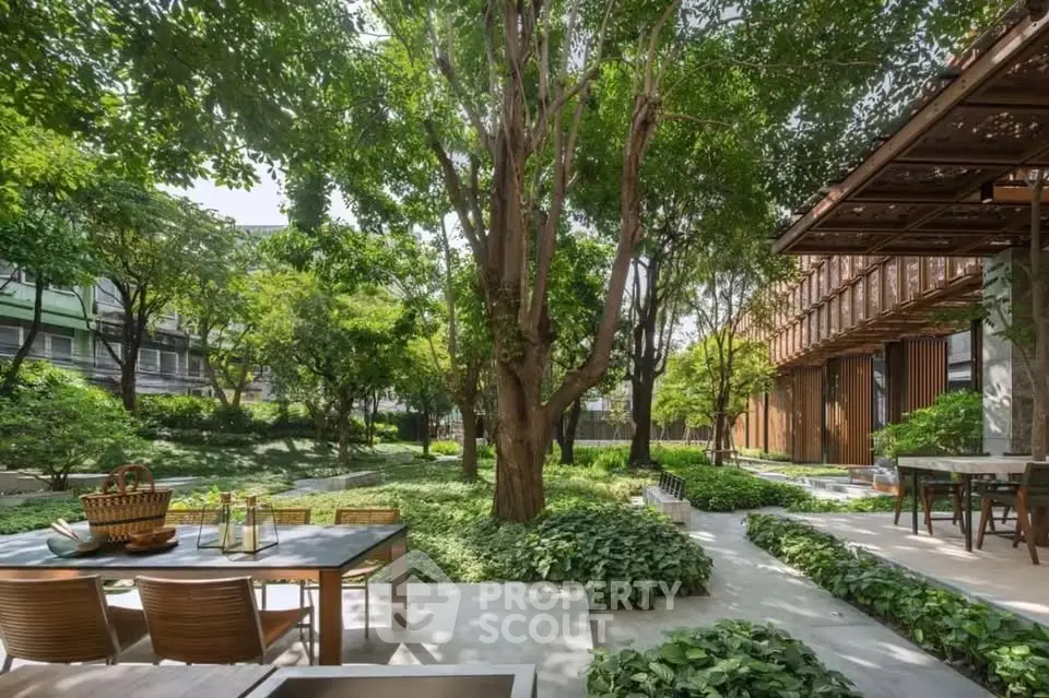 Luxurious garden area with outdoor dining set, lush greenery, and modern architecture.