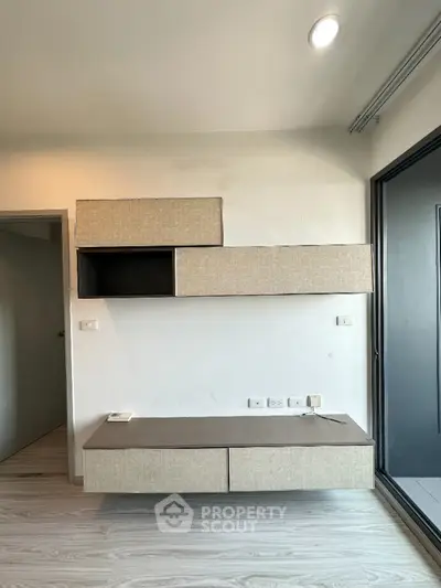 Modern minimalist living room with stylish wall-mounted storage unit