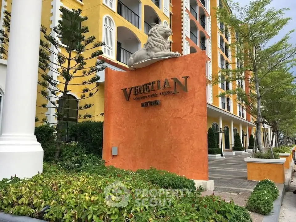 Elegant Venetian-style building exterior with lush landscaping and grand entrance.