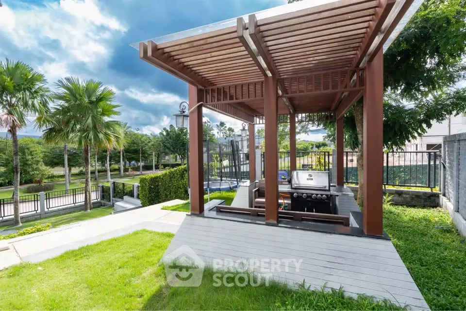 Luxurious outdoor BBQ area with modern pergola and lush greenery