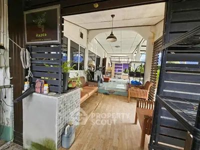 Charming rustic porch with wooden seating and lush greenery, perfect for relaxation.