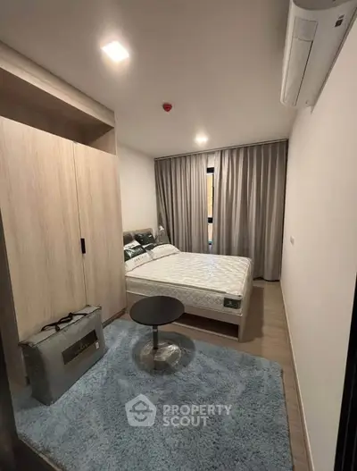Cozy bedroom with modern decor and ample natural light