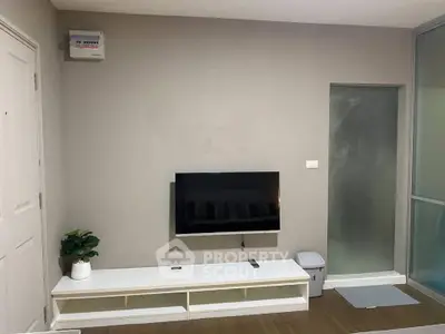 Modern living room with wall-mounted TV and sleek furniture