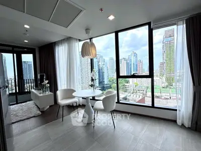 Modern living room with stunning city view and elegant decor in high-rise apartment.