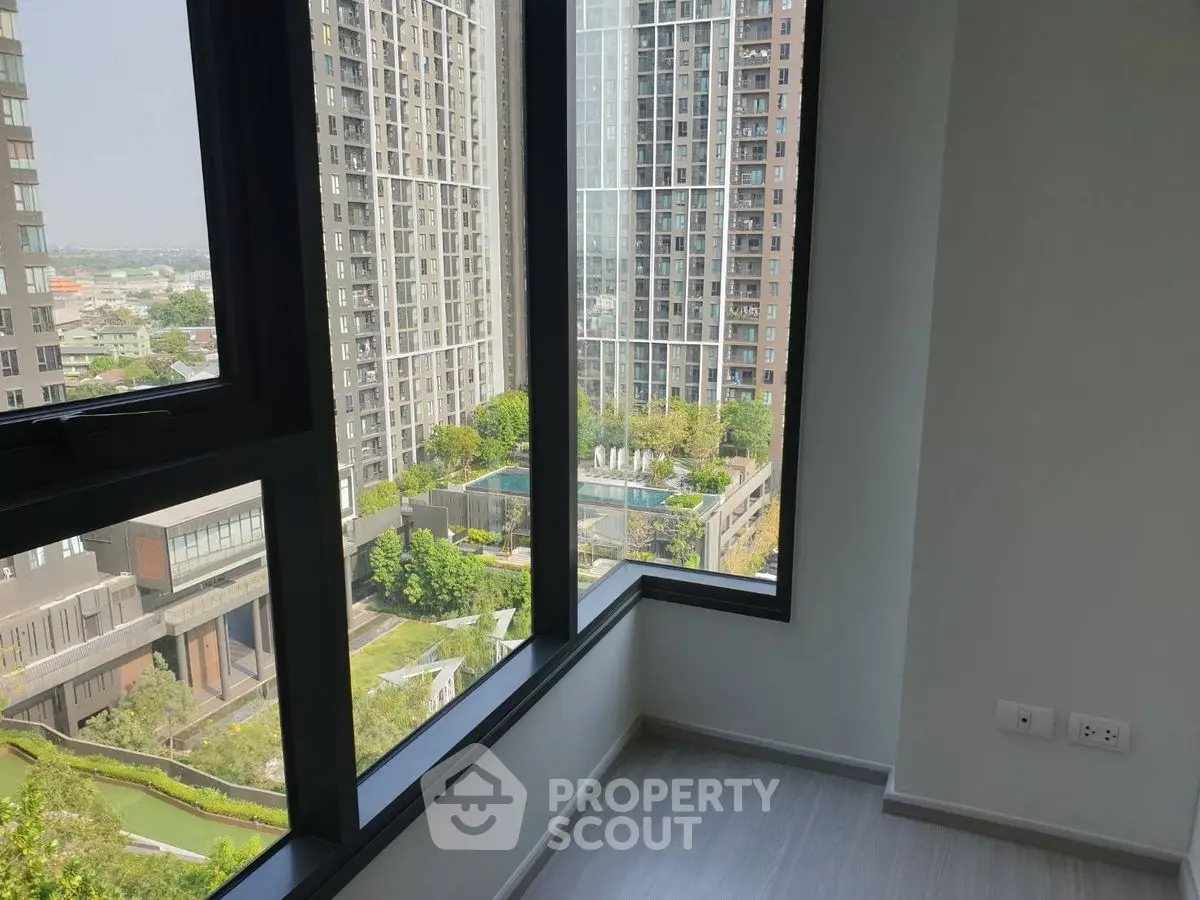 Modern high-rise apartment with panoramic city view and large windows.