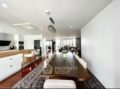 Spacious open-plan living and dining area with modern decor and ample natural light.
