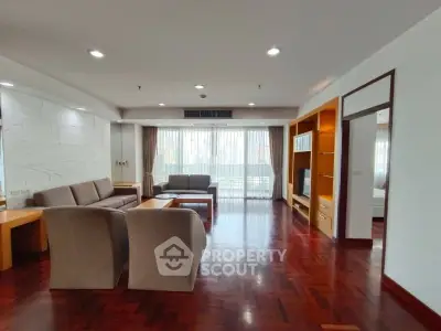 Spacious living room with elegant hardwood floors and modern furniture, perfect for relaxation and entertainment.