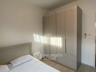 Cozy bedroom with modern wardrobe and natural light