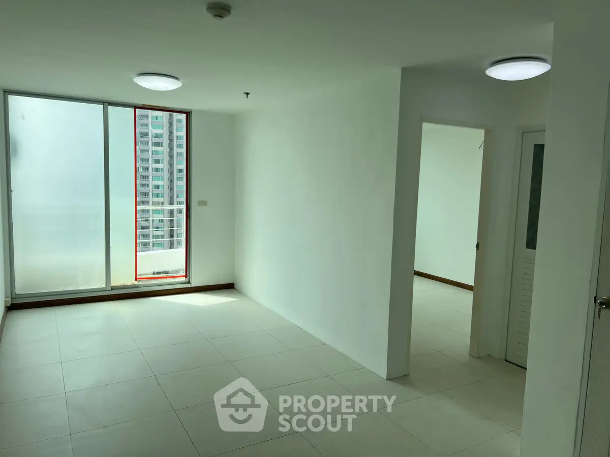 Spacious unfurnished apartment with large windows and bright natural light