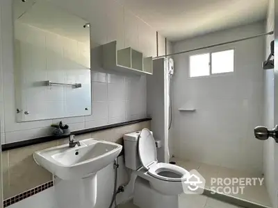 Modern bathroom with sleek fixtures and spacious shower area