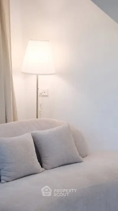 Cozy living room with plush sofa and elegant floor lamp