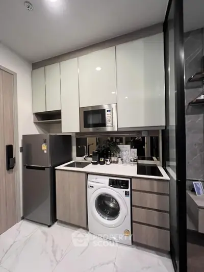 Modern compact kitchen with appliances and sleek cabinetry