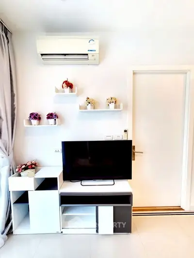 Modern living room with sleek TV stand and wall-mounted air conditioner