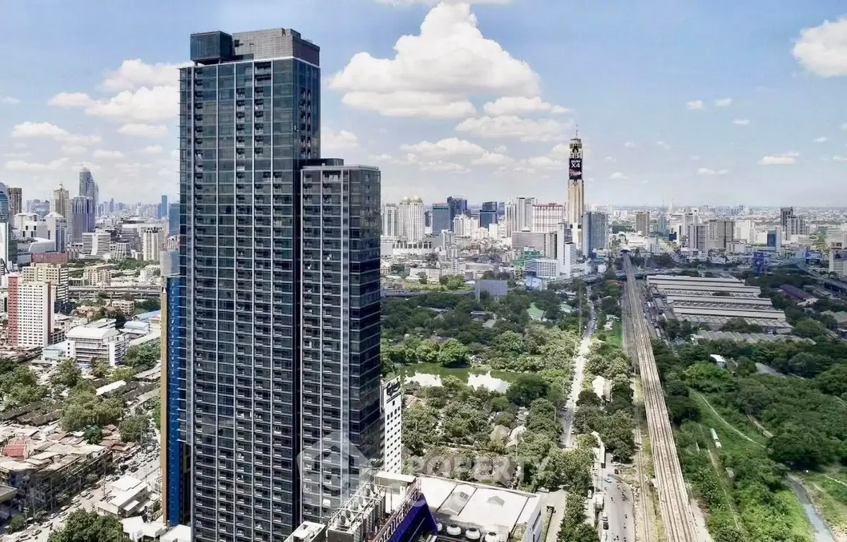 Stunning high-rise building with panoramic city views and lush green surroundings.