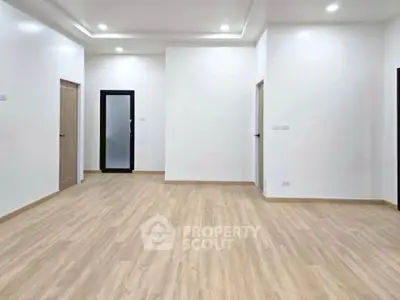 Spacious modern living room with wooden flooring and recessed lighting