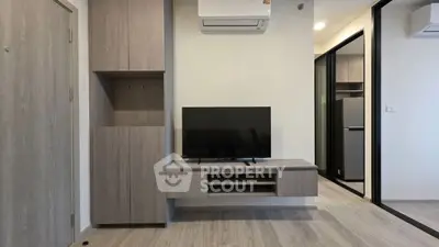 Modern living room with sleek TV unit and air conditioning in stylish apartment.