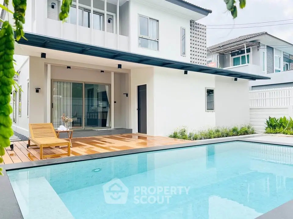 Modern two-story house with a private pool and wooden deck, perfect for luxury living.