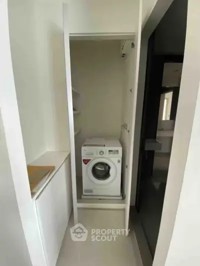 Compact laundry area with washing machine in modern apartment
