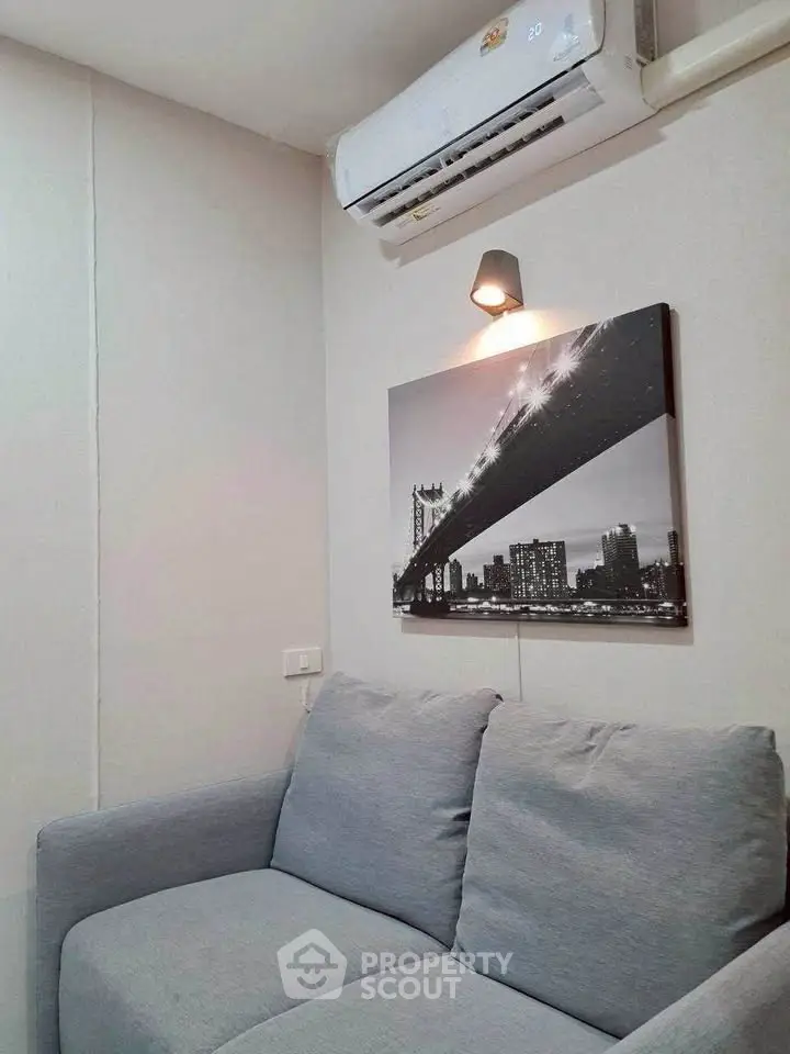 Cozy living room with modern gray sofa and stylish wall art