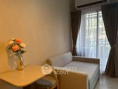 Cozy living room with sofa, table, and window view in modern apartment.