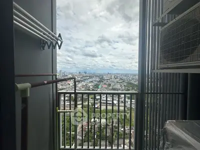 Stunning cityscape view from a high-rise balcony with modern railing and air conditioning unit.