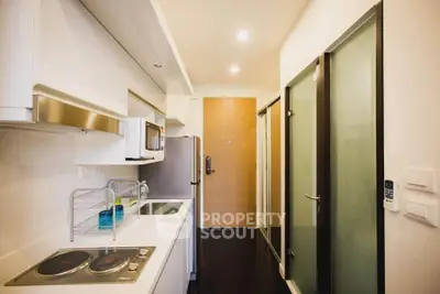 Modern kitchen with sleek design and integrated appliances in a compact layout.