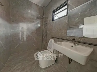 Modern bathroom with sleek design and elegant fixtures in a contemporary home.