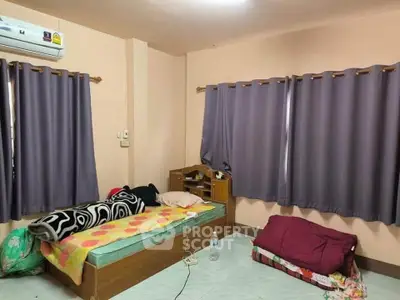 Cozy bedroom with single bed and air conditioning, ideal for comfortable living.