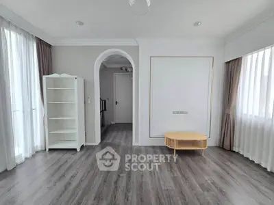 Spacious living room with elegant flooring and natural light