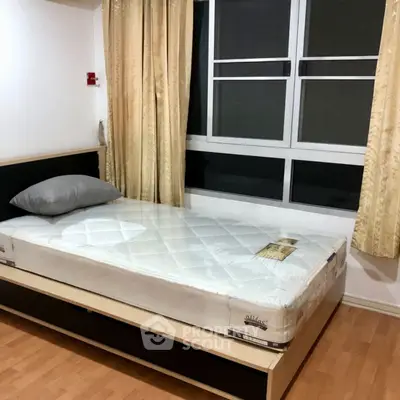 Cozy bedroom with single bed and large window, perfect for natural light lovers.