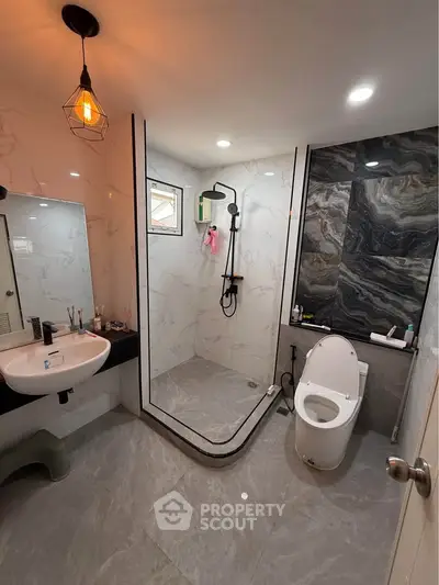 Modern bathroom with sleek shower and stylish fixtures in a contemporary home.