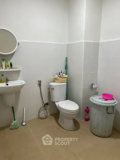 Spacious bathroom with modern fixtures and ample storage space.