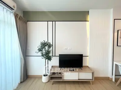 Modern living room with stylish TV stand and potted plant, featuring elegant wall design.