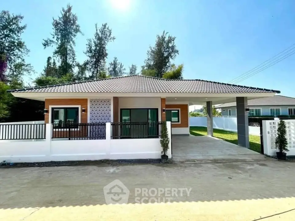 Charming single-story house with modern design and spacious driveway in a serene neighborhood.