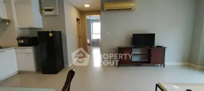 Modern living room with kitchen and TV area in open layout apartment